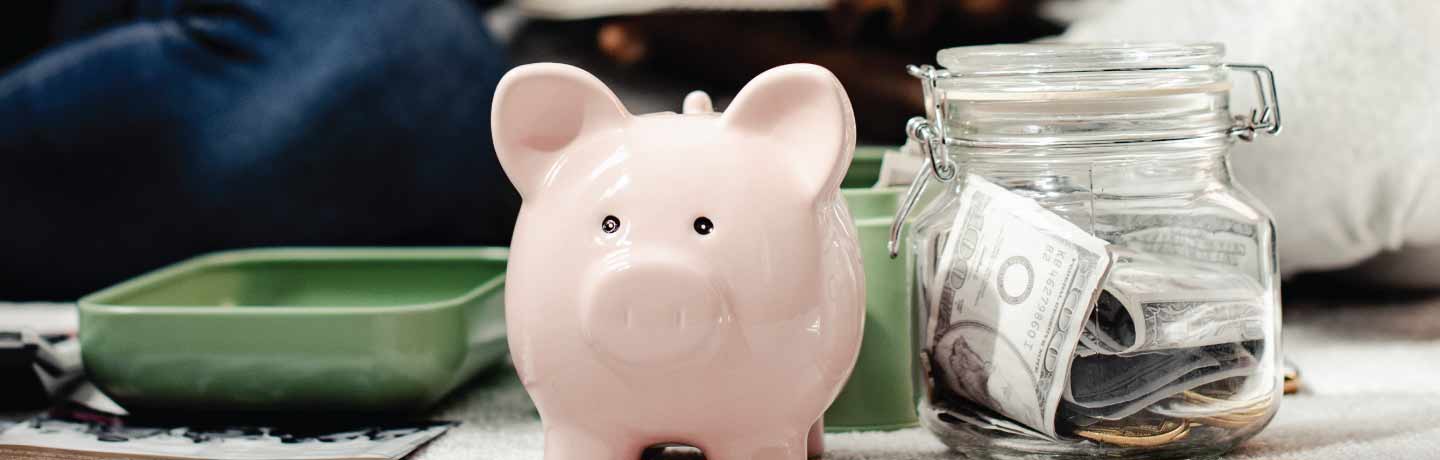 Piggy bank and jar of money
