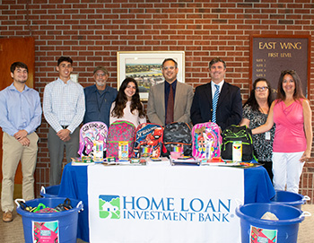 Home Loan Investment Bank employees at school supplies drive